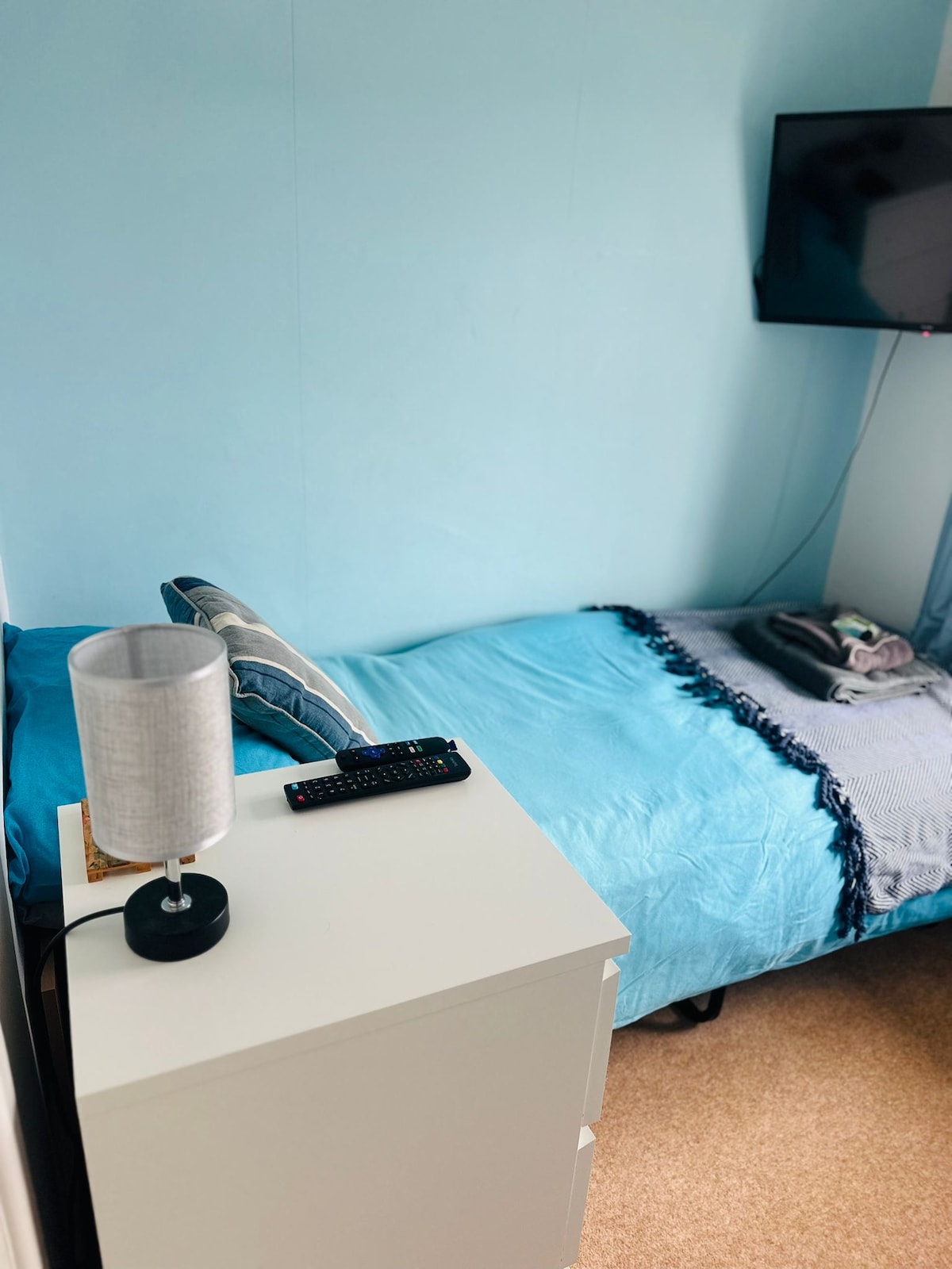 Tretia spálňa má samostatné lôžko a komodu na uloženie oblečenia

Na stene je inteligentný televízor s prístupom k streamovacím kanálom.