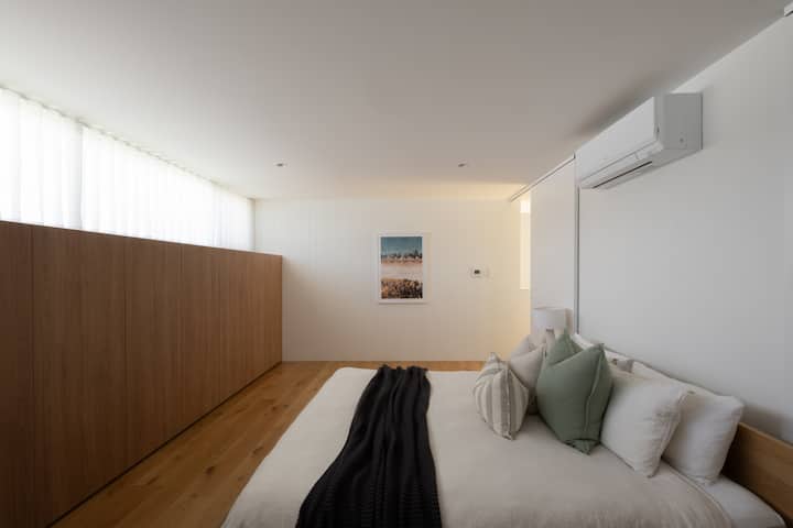 On the first floor is the spacious master suite with a king size bed, built in wardrobes and private ensuite bathroom. Calm, luxurious and inviting with cotton bedding and Totem Road furniture.