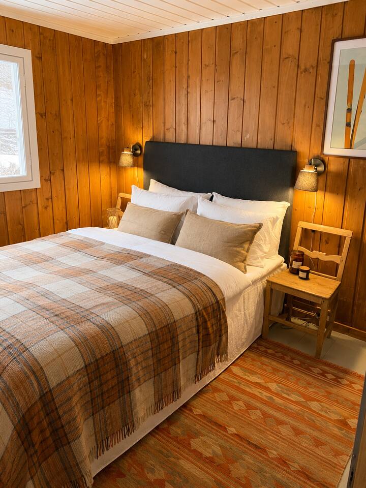 Rustic styled bedroom with double bed and bedside lamps creating a warm light