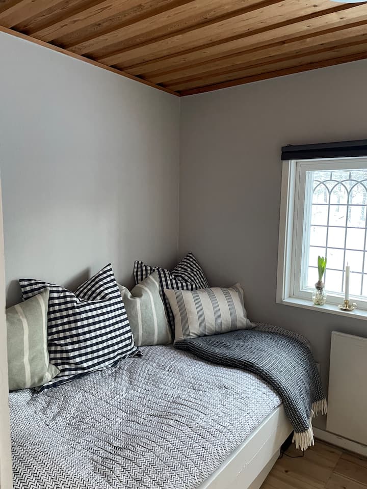 Place-built bed (110 cm wide) in bedroom two, also used as a sofa to watch on TV. 
Recently built a top lap (about 80 cm wide) - see picture two.