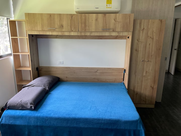 The office has a large corner desk and a murphy bed that opens up into a full size bed and is connected to private bathroom
