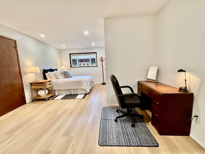 Grande chambre avec un espace de travail dédié, un lit queen confortable et de la lumière naturelle. Idéal pour le télétravail, les séjours prolongés ou les voyageurs à la recherche d'une retraite paisible à la campagne.