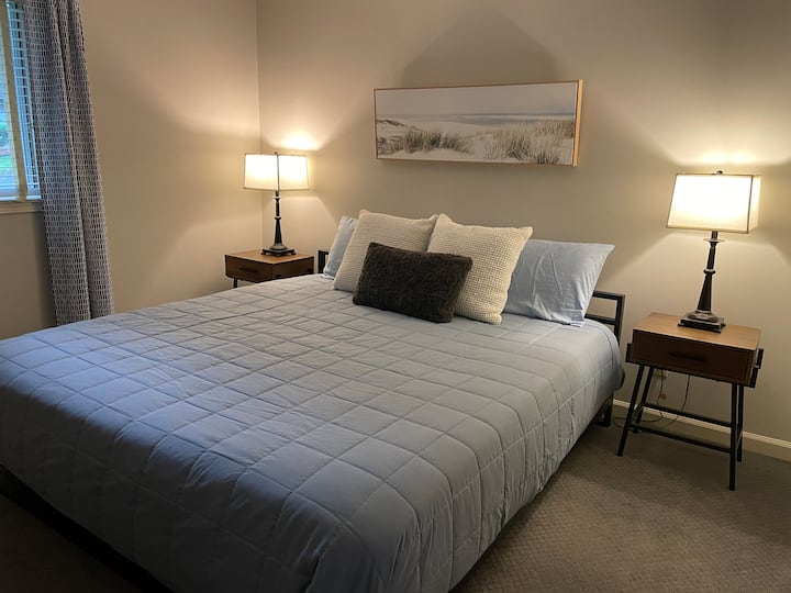 Cama tamaño king en este dormitorio con espacio en el armario y TV.