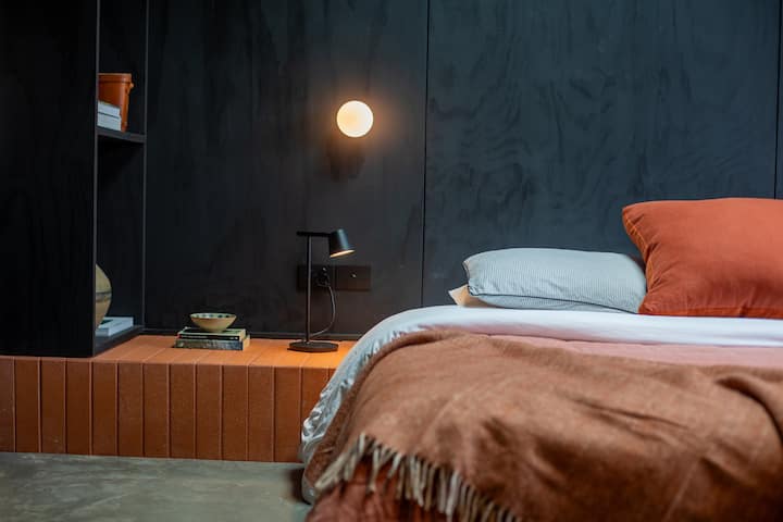 Plush king size bed with beautiful linen, mood lighting and a skylight to see the stars!