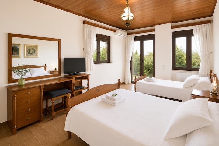 Lower Level - Bedroom 4 with one double and one single bed, ensuite bathroom with jacuzzi bathtub and private patio with garden access