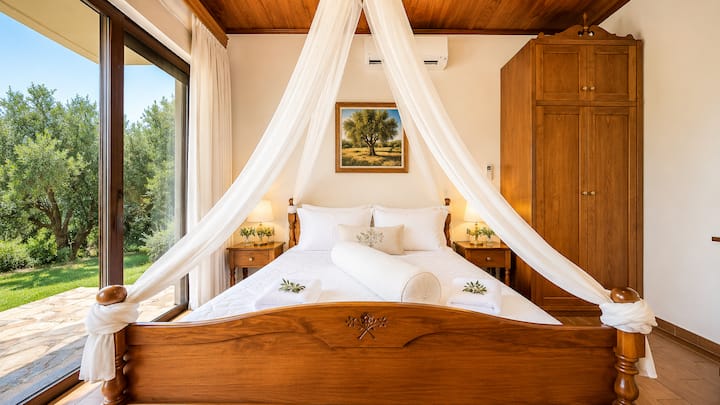 Lower Level - Bedroom 2 with queen bed, ensuite bathroom with jacuzzi bathtub and private patio with garden access.