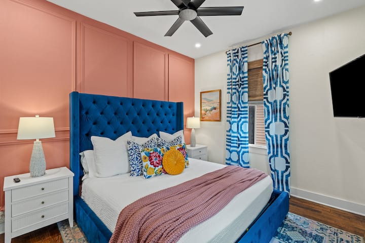 Historic coastal vibes resonate in this bedroom with plush king bed and Pottery Barn bedding. 