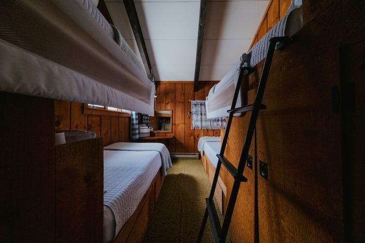 The Bunk Room - located on the 2nd floor with 4 twin size beds (regular twin beds that can sleep adults). 

Room has split unit heated/AC, 2 small closets, drawers under bed, desk (child size), and lots of children books.

Removable ladders on both. 