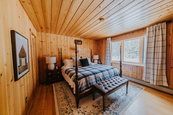 Master king bedroom on ground floor that overlooks the 1 acre lot. Room includes large walk-in closet. In the summer, a window AC unit is added to this room. 