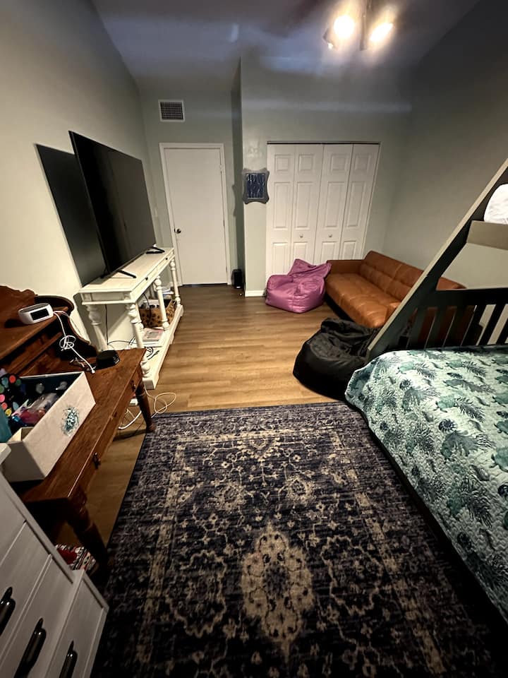 Голяма 3-та спалня с двуетажни легла за възрастни (горното е единично, а долното е с матрак с пълен размер) и легло с колела (единично). Тази детска стая има 70-инчов телевизор.