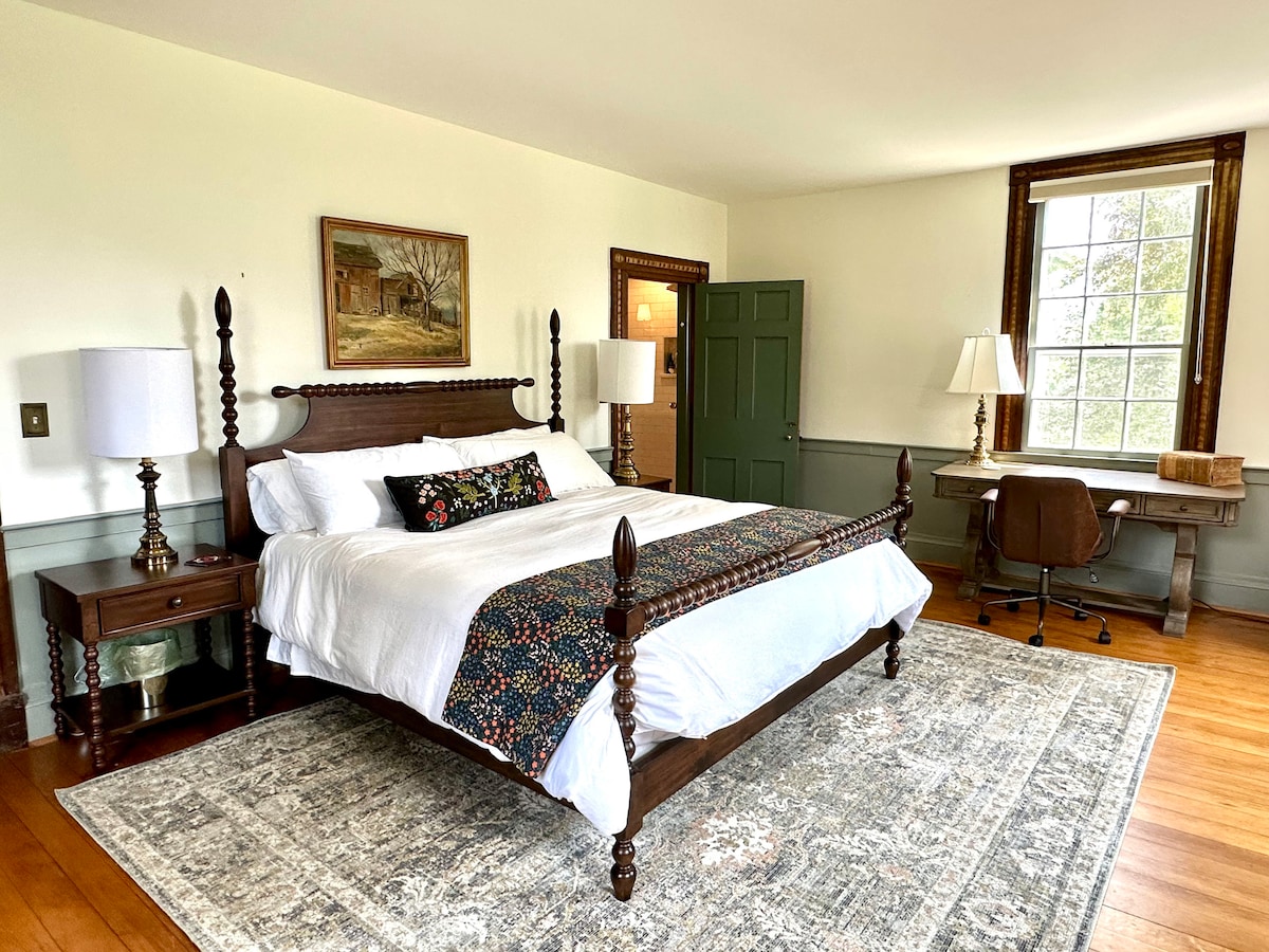 In the Farmhouse: The Library Suite includes a king bed, brand new luxury bathroom, and large desk and chair for remote work.