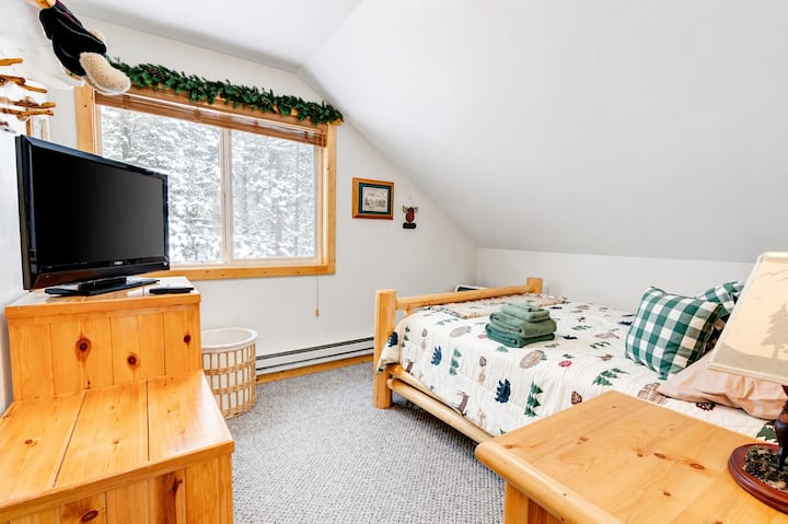 Cozy bedroom with 1 queen bed, warm wood accents, and natural light.