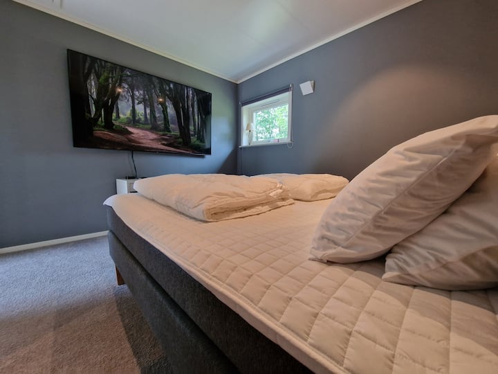 Bedroom with 180 cm double bed and 85 inch Samsung 4K TV and Apple TV 4K.