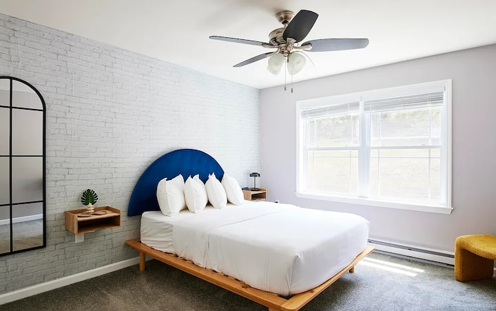 Bedroom 3 is all about those cozy vibes — snuggle into the queen bed with the navy headboard and wake up refreshed for another day of adventures.