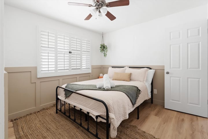 Bright, cozy queen room with shutters, ceiling fan & warm neutrals