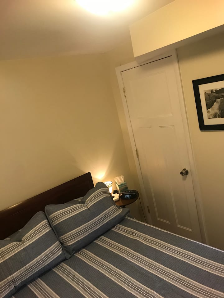 Cama completa en el segundo dormitorio con lámpara junto a la cama, reloj y potencia de conveniencia. El armario puede mantener tus maletas o pertenencias fuera de la vista.  