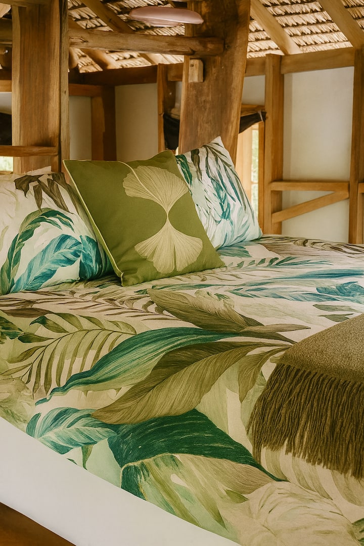 Wake to ocean views straight from bed, framed by timber beams and tropical greenery. Fall asleep to sea breezes and soft island light. A simple, elevated space designed for rest, privacy, and connection to the outdoors. Has mosquito net