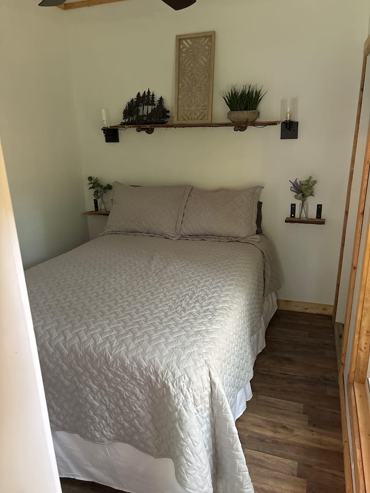 Bedroom has a full size bed, closet, and Samsung smart tv, cell/smart phone charger