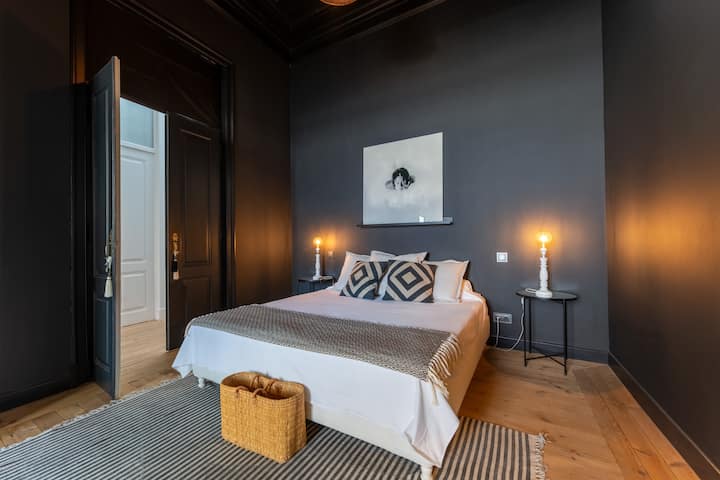 Moody, elegant bedroom with warm lighting and chic modern styling