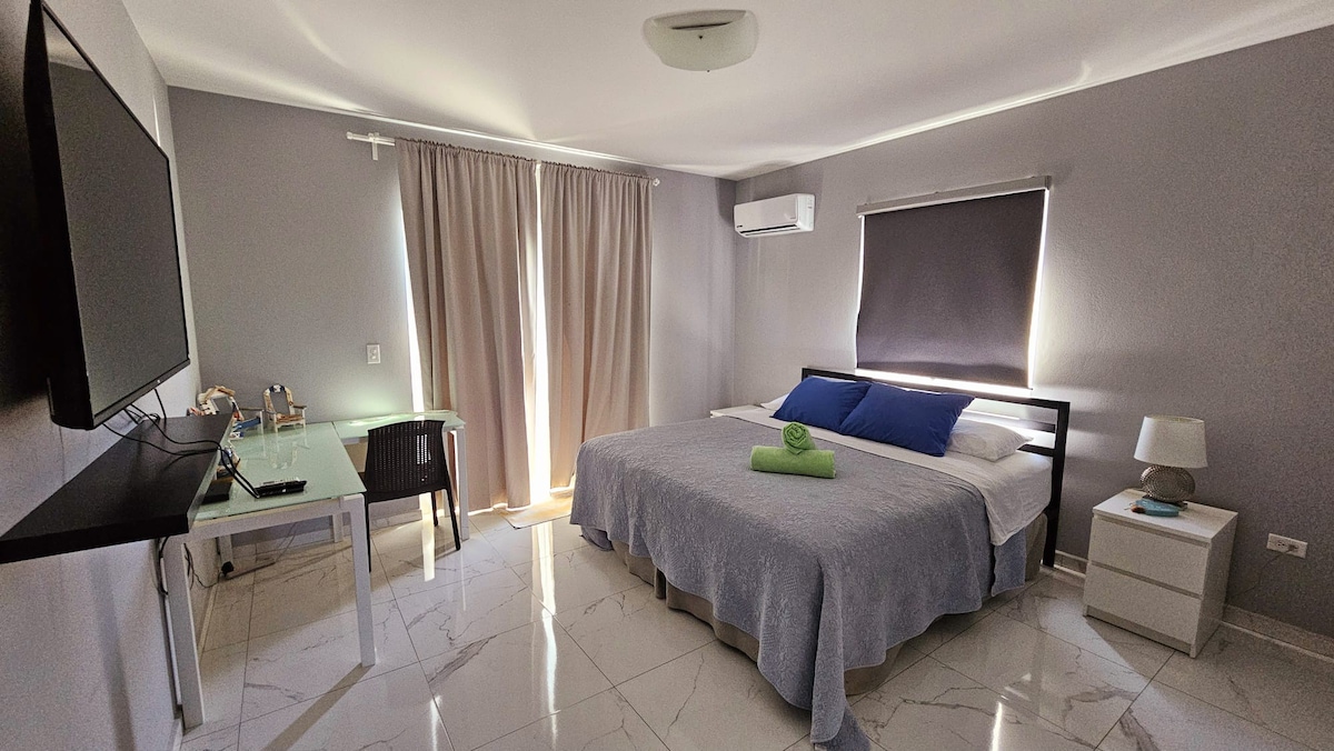 Our master bedroom has a King bed, airconditioning, smart TV, work space, walk in closet and ensuite bathroom. 