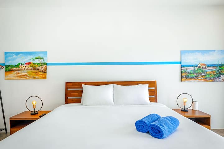 Bedroom 1: Unwind in comfort and style in our bedroom oasis, complete with AC, TV, and a private bathroom. Enjoy the perfect retreat after a day of exploration, where every comfort is tailored to your relaxation. Welcome to your haven away from home.