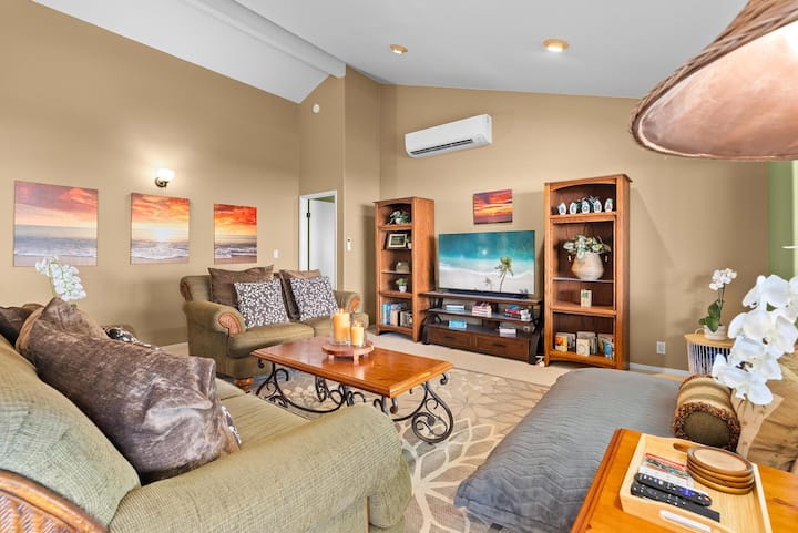 Spacious living room opposite the kitchen with open floor plan. Living room has a new ceiling fan and split AC to keep cool. There's a new 55-inch smart TV and Vizio soundbar for entertainment. Relax on the two sofas or large bean bag lounger.