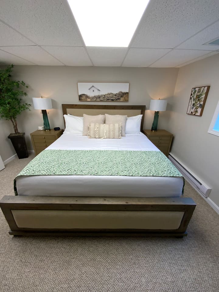 The "Pick 5" room is located on the lower level and features a king size bed, 50" Vizio smart tv, cellular blackout shades, egress window, Elfa drawer solution, hamper and luggage rack.  Additional pillows and blankets are stored in the closet. 