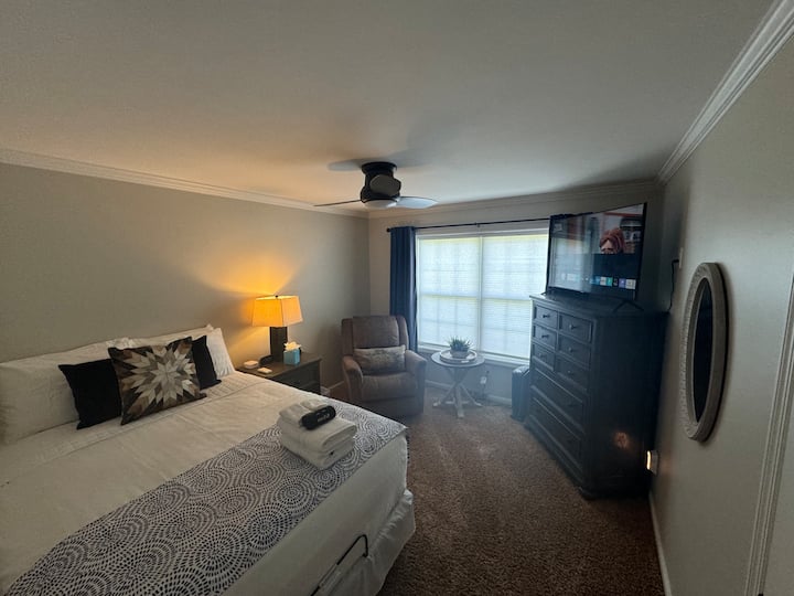 The "Place" bedroom is on the main level and features a queen size adjustable base bed, cellular blackout shades,  55" Samsung smart tv, California Closet, luggage rack and laundry hamper. Additional pillows and blankets are located in each closet. 