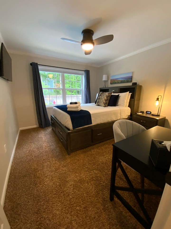The "Show" bedroom is located on the main level and features a queen size bed, cellular blackout shades,  50" Samsung smart tv, California Closets, luggage rack and laundry hamper. Additional pillows and blankets are located in each closet. 