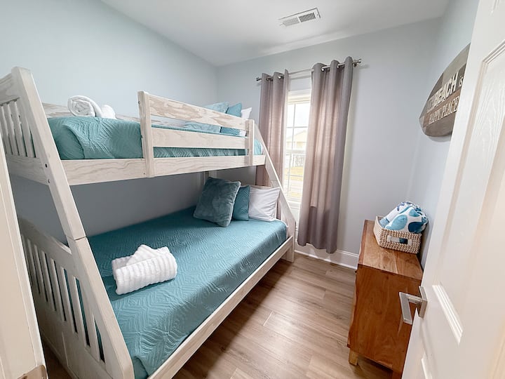 Guest bedroom 2 with twin over full bunk bed. Credenza for clothing storage.