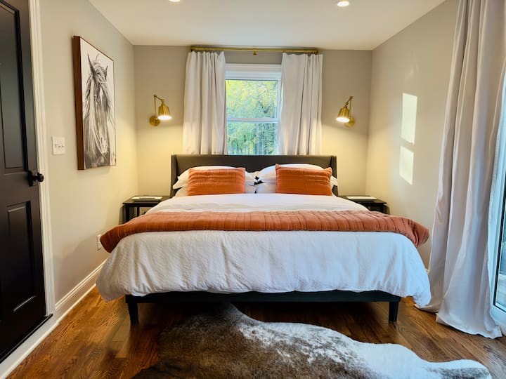 Comfy king sized bed with fluffy duvet and crisp cotton sheets. Lay in bed and view the forest through sliding glass doors that lead to a balcony or binge watch your favorite Netflix series.