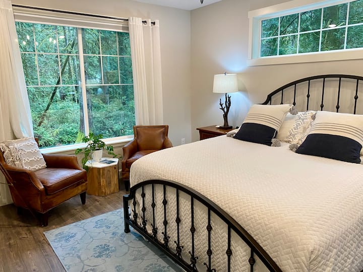 The inviting master bedroom features a king sized bed, a flat screen TV with Sonos soundbar and a sitting area overlooking the forest.  The adjacent master bath includes dual sinks, a high-tech bidet, shower and a separate soaking tub.