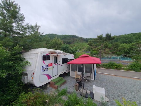 Luxurious caravan like a private hotel in a scenic village in the forest. Forest, river, birdsong, p