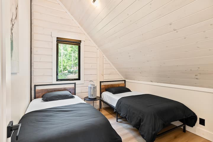 Upper level single beds with sloped ceiling