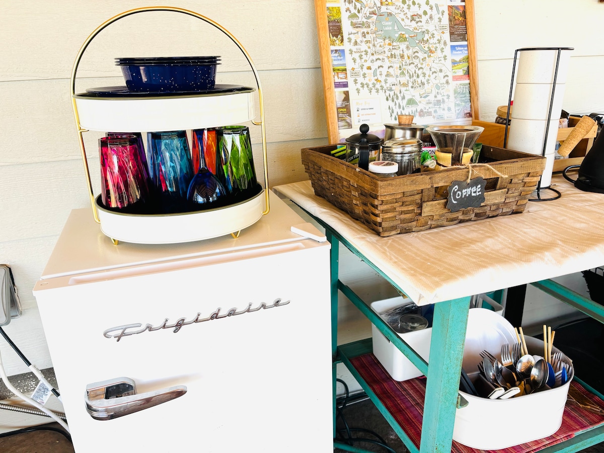 Our kitchen with retro mini fridge, coffee bar, utensils, cooking gear, dish sink, glasses and most of what you need to make a meal. at Bohemian Belle Yurt in Hidden Valley Lake