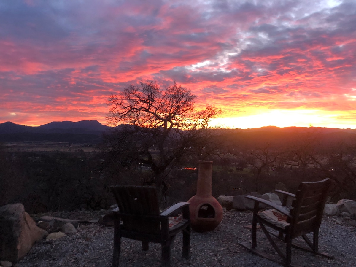 Winter Solstice sunset over the Mayacamas mountains, viewed from our fire chiminea with chairs handmade locally from wine barrels. at Bohemian Belle Yurt in Hidden Valley Lake