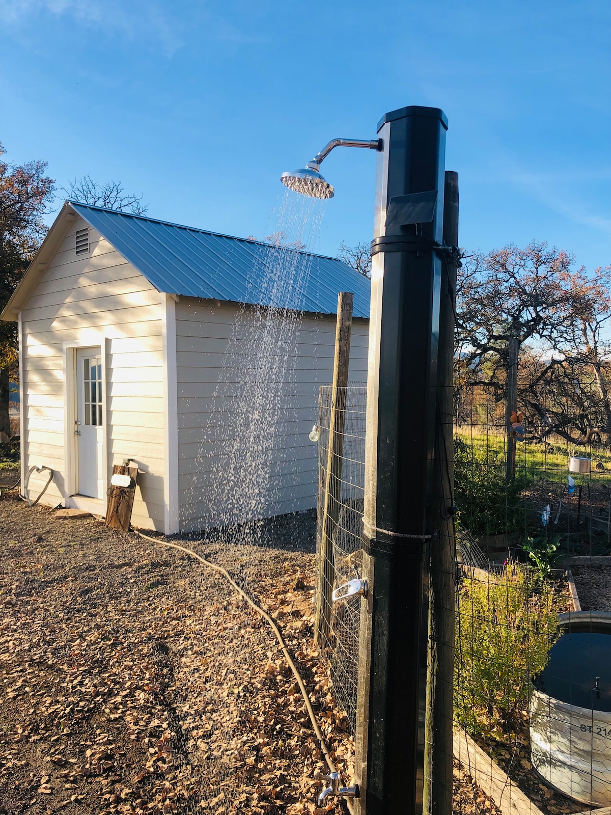 SHARED Outdoor solar shower by the garden is SO refreshing in the hot summer for cooling off. We also have a propane hot shower by Camplux (best one made). This is a 250 foot walk 