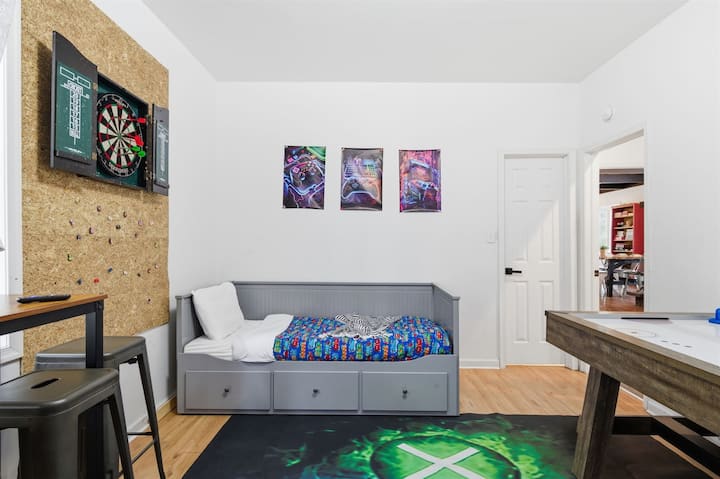 Game Room fun for all ages  — enjoy arcade machines, air hockey, and a dartboard, plus a cozy bar seating area by the window for relaxing between games!