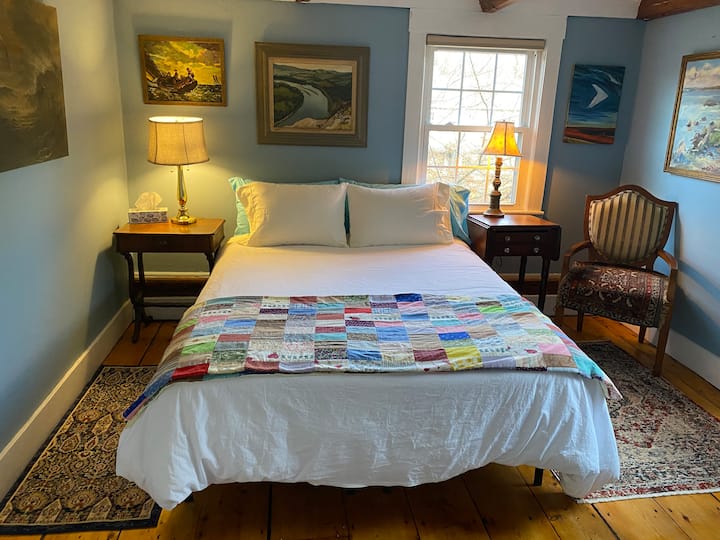 Bedroom at the front of the house. Queen bed, dresser, and all the artwork is water themed. 