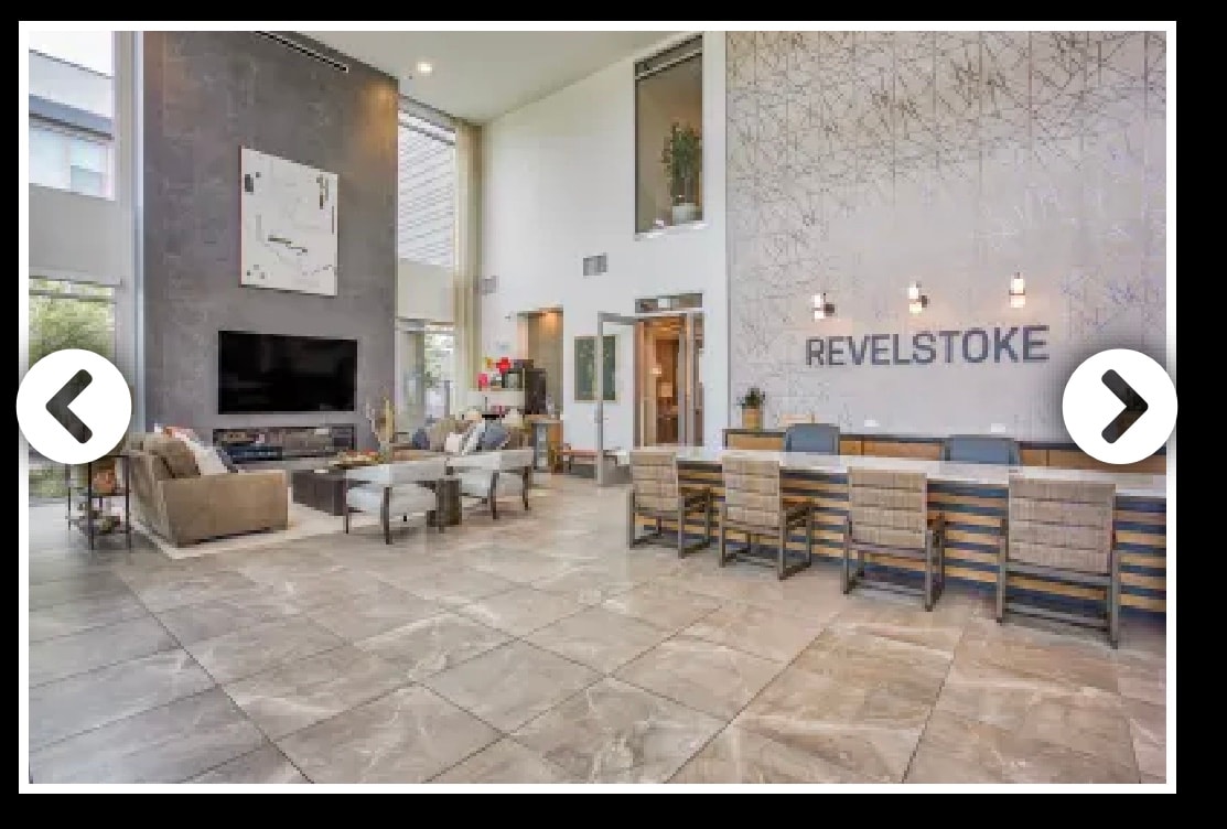 A modern communal space is showcased, featuring a large television mounted on a light-colored wall. Comfortable sofas and chairs surround a coffee table, while a long dining table with woven chairs is positioned nearby. Natural light enters through large windows, enhancing the open atmosphere.