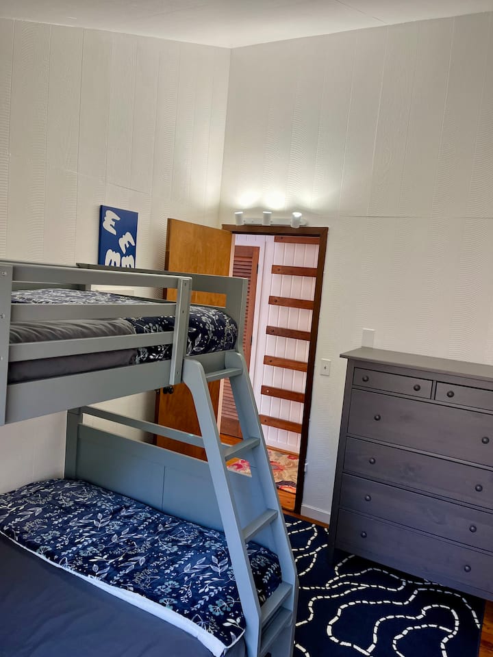 Dormitorio con dos camas individuales sobre una litera completa
