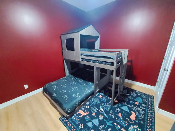 Perfect for families or groups, this fun space features a playhouse-style twin-over-full bunk bed, offering plenty of room for everyone to relax and rest comfortably.