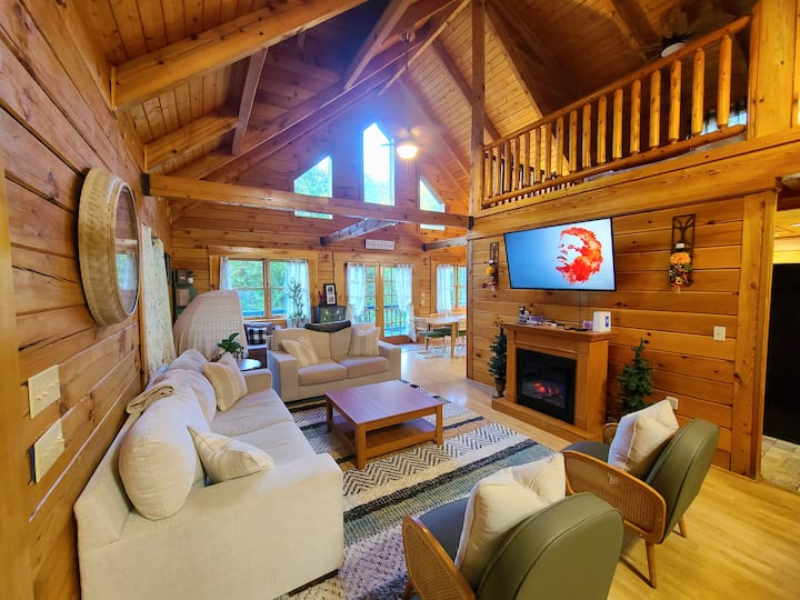 Relax in a cozy space with two large white sofas, three single chairs, and a rattan egg chair. Enjoy movie nights on the TV or unwind by the electric fireplace. A shelf of games and a travel crib make it perfect for families and friends alike.