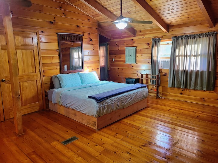 Rest easy in the spacious primary bedroom featuring a king bed and a trundle bed for extra guests. Enjoy added comfort with a private ensuite bathroom complete with a tub and shower,  perfect for relaxing after a long day.