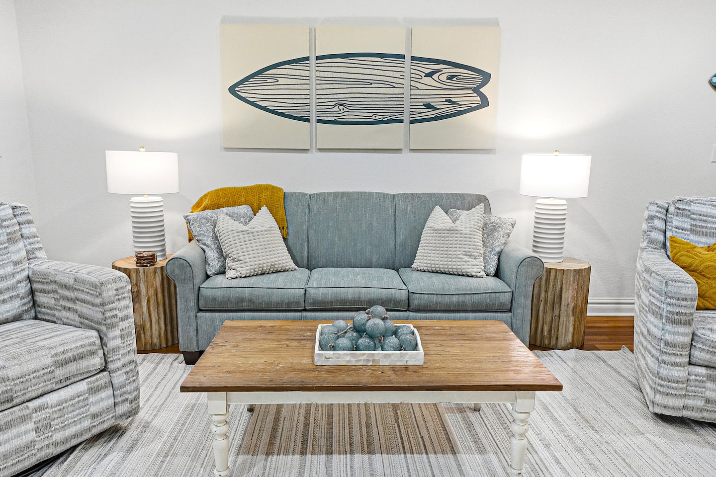 Gather after a sun-soaked beach day in this inviting living room, featuring a queen sleeper sofa, cozy swivel chairs, and easy access to your private balcony with partial ocean views, perfect for morning coffee or evening wine.