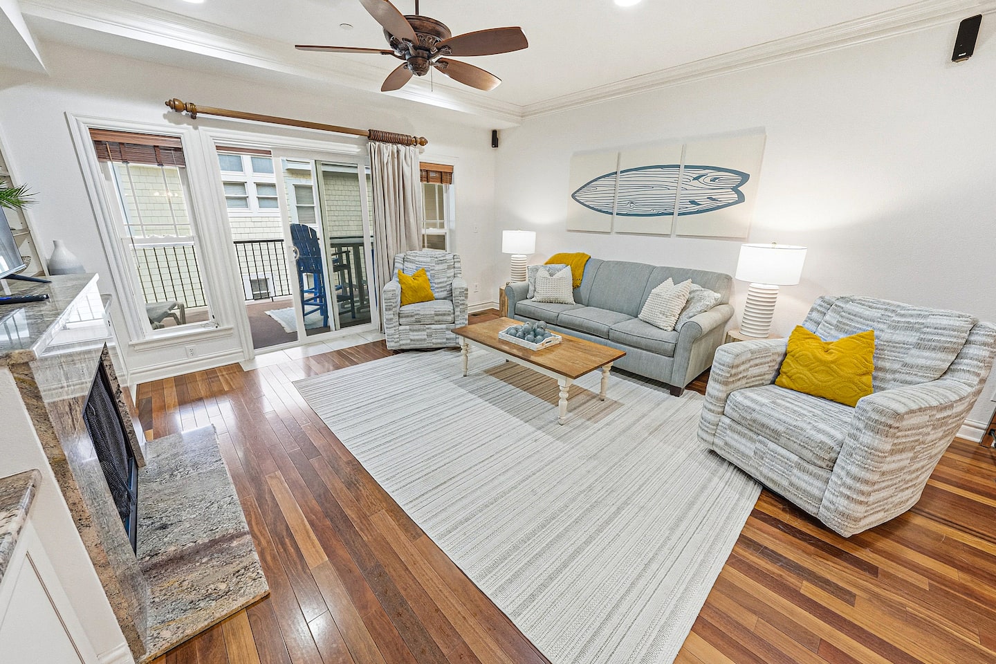 An open, light-filled living space designed for gathering, with comfortable seating, hardwood floors, and direct access to your private balcony for fresh ocean air.