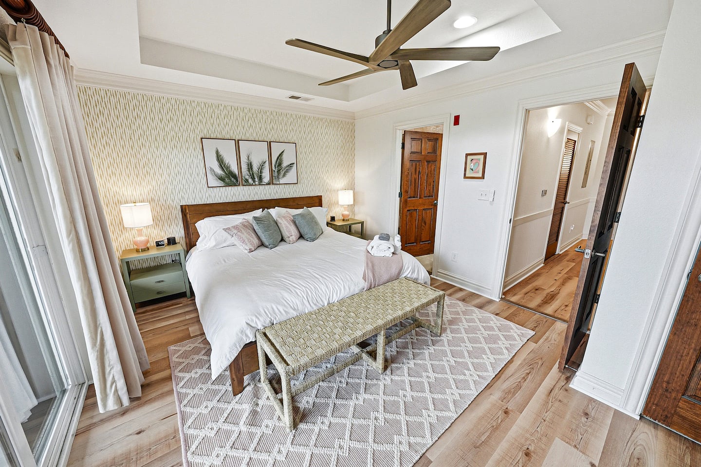 Designed with comfort in mind, this elegant bedroom features layered bedding, plush mattress toppers, soft lighting, and a relaxing coastal atmosphere throughout.