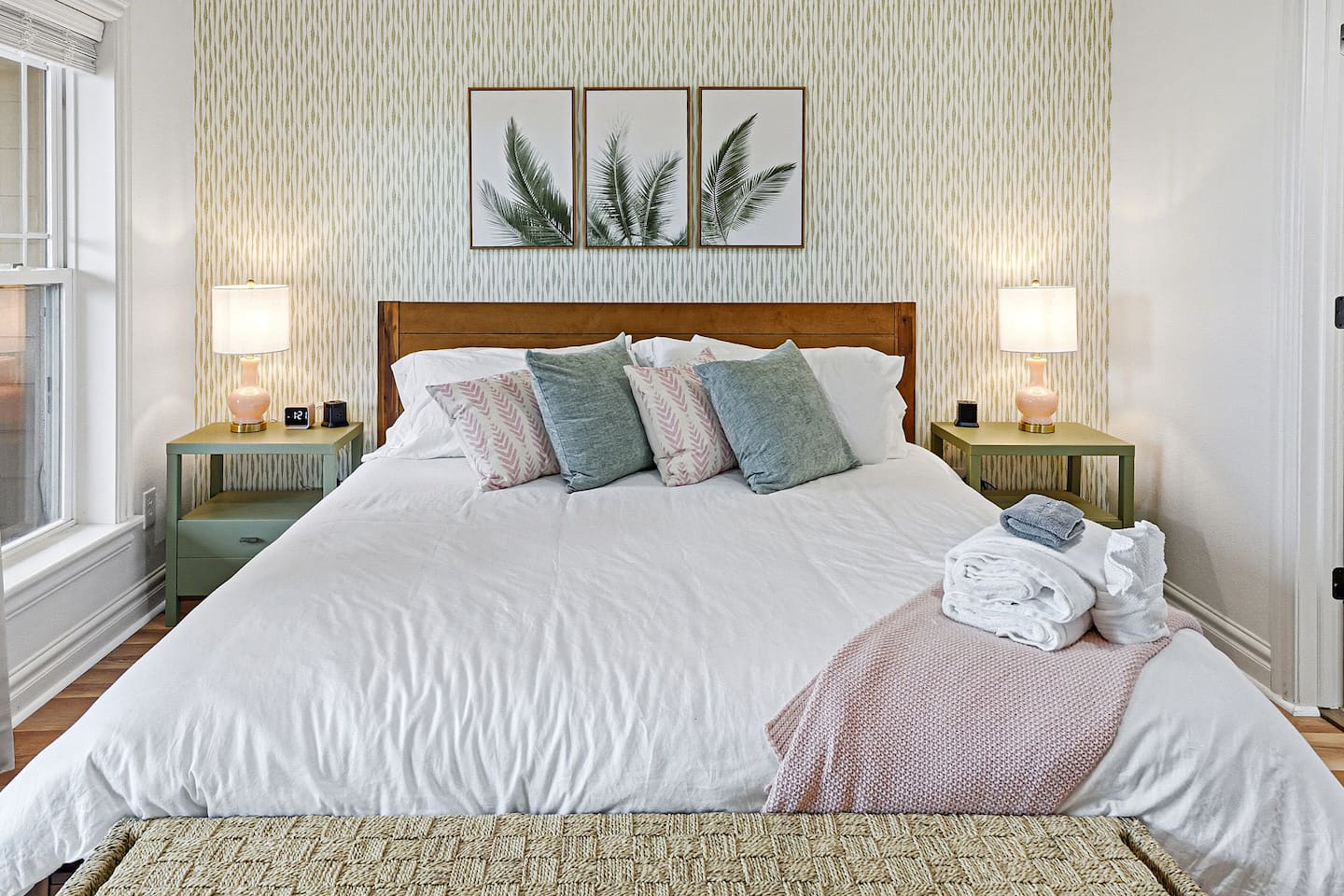 Sink into plush bedding and unwind in this peaceful coastal retreat featuring soft textures, calming décor, and an added mattress topper for extra comfort after a day at the beach.