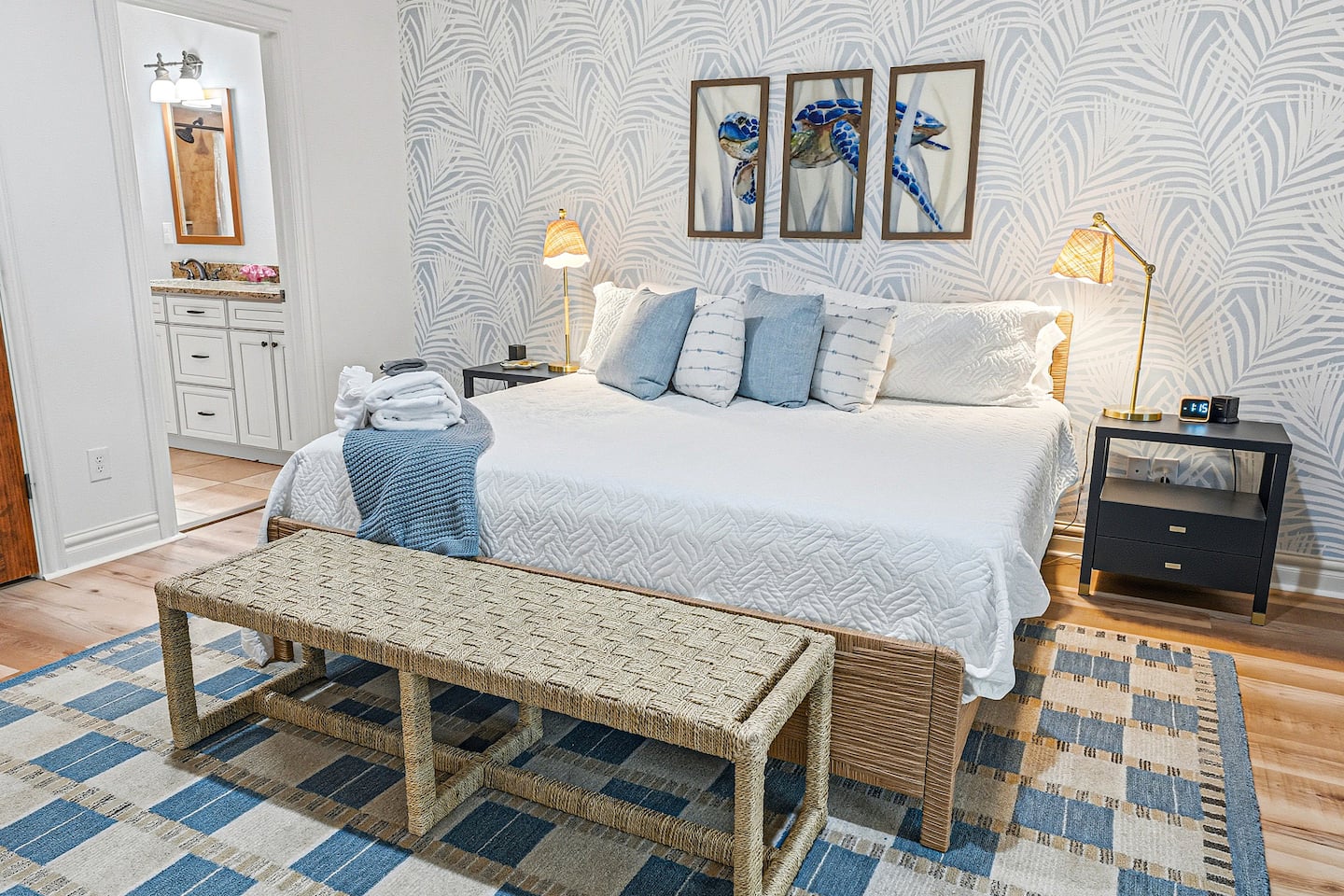Relax and recharge in this spacious king retreat featuring calming coastal décor, plush bedding, and a private ensuite bathroom designed for comfort and convenience.