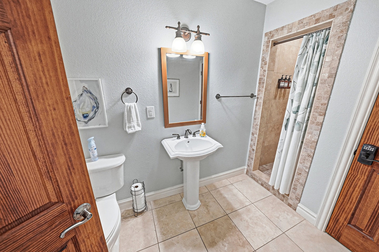 Bright and convenient full bathroom on the main floor featuring a walk-in shower and easy access for family and guests.